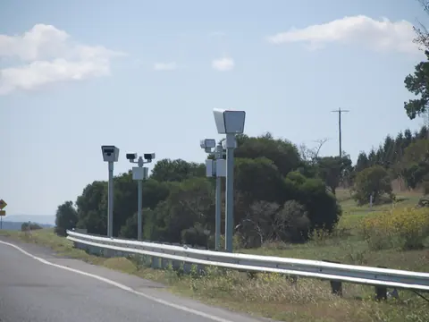 Point-to-point speed cameras on poles beside a highway