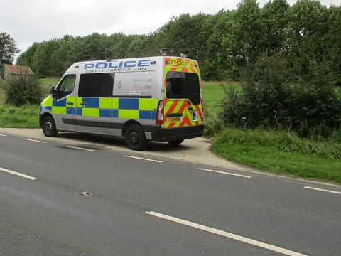 A police safety camera van parked at the side of a country road