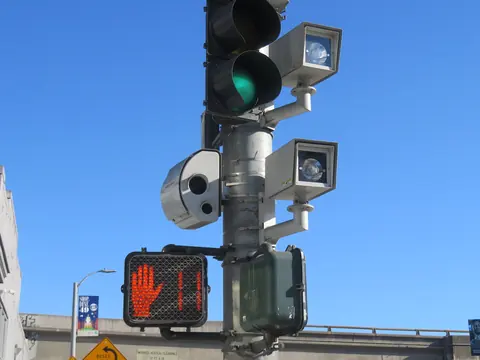 Red light cameras on a traffic signal pole